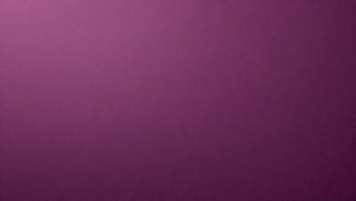 The primary subject of the image is a purple wall. The setting is a room with a purple wall, and the visual style is a close-up of the wall. The colors and mood of the image are predominantly purple, creating a calm and serene atmosphere.