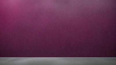 The primary subject of the image is a purple wall. The setting is a room with a purple wall, and the visual style is a photo. The dominant colors in the image are purple and pink, creating a calm and soothing atmosphere.