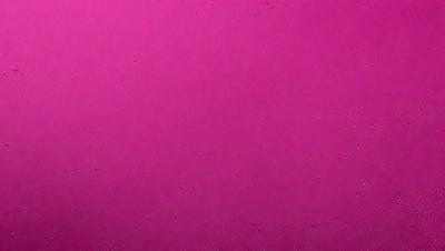 The primary subject of the image is a large, pink wall. The setting is a room with a pink surface, which gives the room a warm and inviting atmosphere. The visual style of the image is a close-up of the pink wall, showcasing its texture and color. The dominant colors in the image are pink, which creates a sense of warmth and comfort.