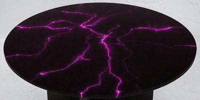 The primary subject of the image is a purple table with a purple lightning design on it. The table is placed on a black surface, which adds contrast to the purple lightning design. The visual style of the image is a combination of digital art and illustration, creating a unique and eye-catching design. The colors and mood of the image are predominantly purple, with a touch of black, giving it a bold and striking appearance.