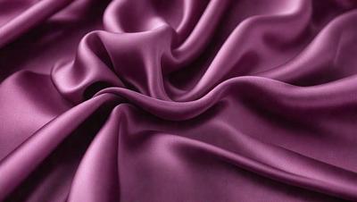 The primary subject of the image is a purple fabric, which is the main object, scene, or focus of the image. The setting or background is a purple fabric, and the visual style is a photo. The colors and mood of the image are predominantly purple, creating a calm and soothing atmosphere.