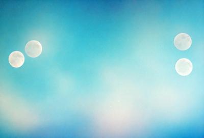 The primary subject of the image is a moon in the sky, which is set against a blue cloudy sky. The visual style of the image is a painting, and the colors and mood convey a sense of tranquility and serenity.