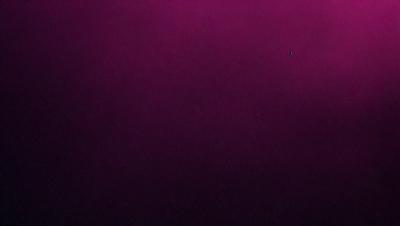 The primary subject of the image is a purple background. The setting/background is a dark purple surface, which creates a moody and dramatic atmosphere. The visual style of the image is a close-up of the purple background, emphasizing the richness of the color.