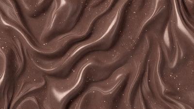The primary subject of the image is a close-up of a brown, textured surface, possibly a piece of fabric or a wall. The setting appears to be a room with a brown color scheme. The visual style of the image is a close-up, which emphasizes the details of the surface. The colors and mood of the image are predominantly brown, creating a warm and cozy atmosphere.