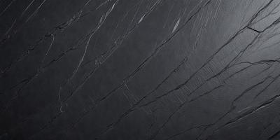 The primary subject of the image is a close-up of a black marble wall. The setting is a dark room, and the visual style is a photo. The dominant colors are black and grey, creating a moody atmosphere.