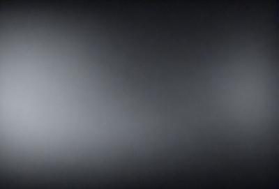 The image is a black and white photo of a dark, empty room. The room appears to be a large, open space with no visible furniture or decorations. The overall atmosphere is one of emptiness and simplicity.