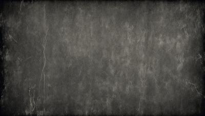 The primary subject of the image is a gray wall with a textured surface. The setting is a room with a gray background. The visual style is a close-up of the gray wall, which gives it a textured appearance. The colors and mood of the image are predominantly gray, creating a calm and neutral atmosphere.