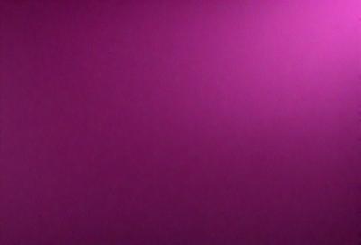 The primary subject of the image is a purple wall. The setting is a room with a purple wall, and the visual style is a close-up of the wall. The dominant colors in the image are purple, and the overall atmosphere is calm and serene.
