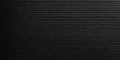 The primary subject of the image is a black and white patterned surface. The setting is a black background, and the visual style is a patterned texture. The dominant colors are black and white, creating a mood of simplicity and elegance.