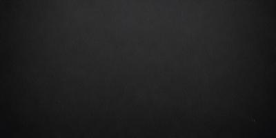The primary subject of the image is a black background. The setting is a dark room, and the visual style is a black and white photo. The colors and mood of the image are dark and moody, creating a sense of mystery or drama.
