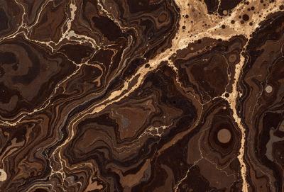 The primary subject of the image is a close-up of a marble countertop with a brown and gold color scheme. The setting is a kitchen or bathroom counter, and the visual style is a realistic representation of the marble surface. The colors and mood of the image are warm and inviting, with the brown and gold tones creating a sense of luxury and sophistication.