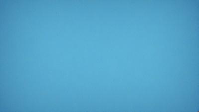The primary subject of the image is a large, empty blue sky. The setting is a vast, open space with no visible landmarks or objects. The visual style is a natural, outdoor scene with a focus on the sky. The colors and mood are predominantly blue, creating a calm and serene atmosphere.