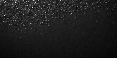 The primary subject of the image is a close-up of a black background with a pattern of glittering silver stars. The setting is a dark room, and the visual style is a combination of a photo and digital art. The dominant colors are black and silver, creating a moody and dramatic atmosphere.