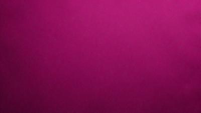 The primary subject of the image is a large, pink surface. The setting is a room with a pink wall, and the visual style is a close-up of the pink wall. The colors and mood of the image are predominantly pink, creating a warm and inviting atmosphere.