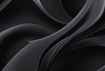 The primary subject of the image is a black and white photograph of a spiral pattern. The setting is a black background, which emphasizes the spiral pattern. The visual style is a black and white photo, giving it a classic and timeless appearance. The colors and mood of the image are predominantly black and white, creating a sense of depth and contrast.