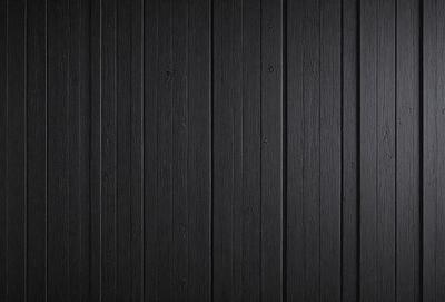 The primary subject of the image is a wooden wall. The setting is a black wall, which creates a contrast with the wooden surface. The visual style is a close-up of the wooden wall, showcasing its texture and details. The colors and mood of the image are predominantly black, giving it a moody and dramatic appearance.