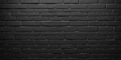 The primary subject of the image is a black brick wall. The setting is a dark room, and the visual style is a close-up of the brick wall. The colors and mood of the image are predominantly dark, with the black brick wall being the main focus.
