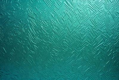 The primary subject of the image is a close-up of a green and blue patterned wall. The setting is indoors, with the wall being the main focus of the scene. The visual style appears to be a combination of digital art and illustration, creating a unique and intricate pattern. The dominant colors in the image are green and blue, giving the wall a vibrant and lively atmosphere.