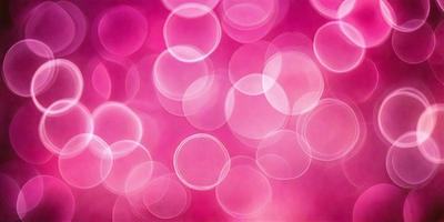 The primary subject of the image is a pink background with a pattern of pink and white circles. The setting is a close-up of the pink background, which creates a visually appealing and vibrant scene. The visual style of the image is a combination of a photo and digital art, as it features a pink and white circle pattern that is both realistic and artistic. The colors and mood of the image are predominantly pink and white, creating a warm and inviting atmosphere.