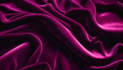 The primary subject of the image is a purple fabric, which is the main object, scene, or focus of the image. The setting or background is a purple sheet, and the visual style is a photo. The colors and mood of the image are predominantly purple, creating a calm and soothing atmosphere.