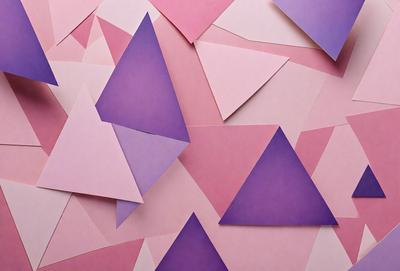 The primary subject of the image is a collection of variously shaped and colored paper triangles. These triangles are arranged in a visually appealing manner, creating a sense of depth and dimension. The setting is a pink background, which adds a warm and inviting tone to the scene. The visual style of the image is a combination of digital art and illustration, as the paper triangles are carefully crafted and arranged to create a cohesive and visually striking pattern. The colors and mood of the image are pre