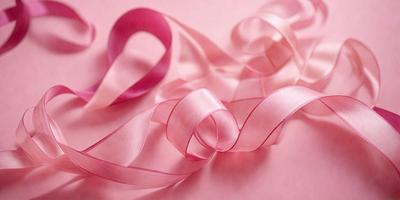 The primary subject of the image is a pink ribbon. The ribbon is wrapped around a pink surface, creating a visually appealing and elegant presentation. The setting appears to be a pink background, which complements the color of the ribbon. The visual style of the image is a close-up of the pink ribbon, emphasizing its texture and details. The colors and mood of the image are predominantly pink, creating a warm and inviting atmosphere.