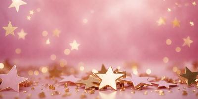 The primary subject of the image is a collection of gold star-shaped decorations. These stars are arranged on a pink background, creating a visually appealing and festive scene. The setting appears to be a table or a surface where the stars are placed, and the visual style is a close-up of the gold stars. The colors and mood of the image are predominantly pink and gold, giving it a warm and celebratory atmosphere.