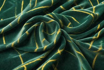 The primary subject of the image is a green and yellow fabric, which is the main object, scene, or focus of the image. The setting is a table, and the visual style is a photo. The colors and mood of the image are predominantly green and yellow, creating a warm and vibrant atmosphere.
