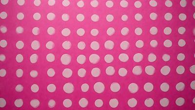 The primary subject of the image is a pattern of dots on a pink background. The dots are white and are arranged in a circular pattern. The setting is a pink surface, which creates a visually striking contrast with the white dots. The visual style of the image is a combination of digital art and illustration, as it features a well-defined and organized pattern. The colors and mood of the image are predominantly pink and white, giving it a clean and fresh appearance.