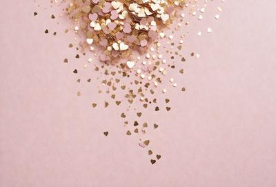 The primary subject of the image is a pink background with gold hearts scattered across it. The hearts are of various sizes and are placed in different positions on the pink surface. The setting appears to be a creative and artistic environment, possibly for a craft project or a design inspiration. The visual style of the image is a combination of digital art and illustration, creating a unique and eye-catching design. The colors and mood of the image are warm, inviting, and playful, with the pink background and