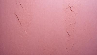 The primary subject of the image is a pink wall with a peeling paint surface. The setting is a room with a pink background. The visual style is a close-up of the pink wall, showcasing the peeling paint. The colors and mood of the image are predominantly pink, giving it a warm and inviting atmosphere.