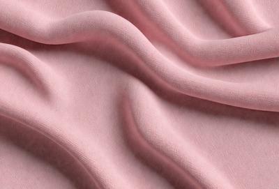 The primary subject of the image is a pink fabric, which is the main object, scene, or focus of the image. The setting or background is a pink sheet, and the visual style is a photo. The colors and mood of the image are predominantly pink, creating a warm and inviting atmosphere.