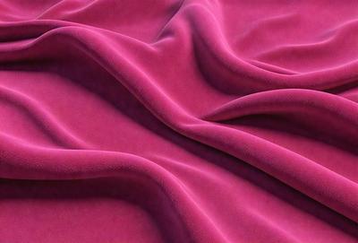 The primary subject of the image is a pink fabric, which is the main object, scene, or focus of the image. The setting or background is a pink sheet, and the visual style is a photo. The colors and mood of the image are predominantly pink, creating a warm and inviting atmosphere.