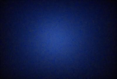 The primary subject of the image is a blue sky with a few clouds. The setting is a dark blue background, which creates a contrasting effect with the lighter blue sky. The visual style is a photo, capturing the natural beauty of the sky. The colors and mood of the image are predominantly dark blue, creating a calm and serene atmosphere.