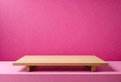 The primary subject of the image is a wooden bench. The bench is placed on a pink wall, which serves as the setting and background of the scene. The visual style of the image is a photo, capturing the wooden bench and the pink wall in a realistic manner. The colors and mood of the image are predominantly pink, creating a warm and inviting atmosphere.