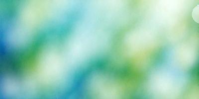 The primary subject of the image is a blue and green background with a patterned texture. The setting is a colorful, abstract environment, and the visual style is a combination of photo and digital art. The dominant colors are blue and green, creating a calming and serene atmosphere.