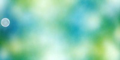 The primary subject of the image is a green and blue patterned background. The setting is a colorful, abstract design that creates a vibrant and lively atmosphere. The visual style is a combination of digital art and illustration, with a focus on the colorful and dynamic pattern. The colors and mood of the image are predominantly green and blue, with a sense of energy and creativity.