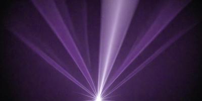 The primary subject of the image is a purple light beam, which appears to be a light source or a light effect. The setting is a dark background, which contrasts with the purple light beam. The visual style of the image is a combination of a photo and a digital art, as it captures the purple light beam in a unique and artistic manner. The colors and mood of the image are predominantly purple, creating a sense of depth and intrigue.