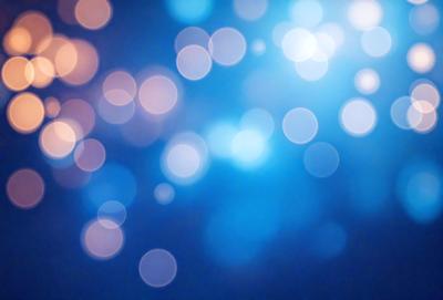 The primary subject of the image is a blue background with a pattern of bright lights, creating a visually appealing and dynamic scene. The setting appears to be a nighttime cityscape, with the lights illuminating the area. The visual style of the image is a combination of photo and digital art, as it captures the essence of a vibrant cityscape at night. The colors and mood of the image are predominantly blue, with the bright lights adding a sense of energy and excitement to the scene.