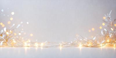 The primary subject of the image is a string of lights, which are illuminated and create a warm and inviting atmosphere. The lights are strung together, creating a visually appealing pattern. The setting is a white wall, which provides a clean and minimalistic backdrop for the lights. The visual style of the image is a close-up of the string of lights, emphasizing their glow and texture. The colors and mood of the image are predominantly warm and soothing, with the lights creating a sense of