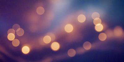 The primary subject of the image is a cloudy sky filled with bright lights. The setting is a dark, cloudy sky, and the visual style is a photo. The colors and mood of the image are predominantly dark and moody, with the bright lights creating a contrasting effect.