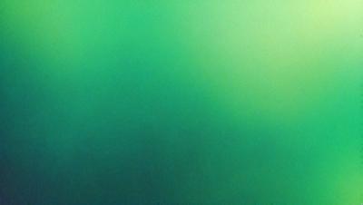 The primary subject of the image is a green background. The setting is a dark, green environment, which creates a moody atmosphere. The visual style is a photo, capturing the vibrant green hue.