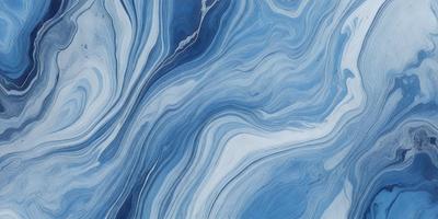 The primary subject of the image is a blue and white ocean wave. The setting is the ocean, with the wave being the main focus of the image. The visual style is a close-up of the wave, showcasing its details. The dominant colors are blue and white, creating a serene and calming atmosphere.