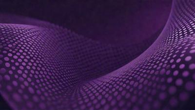 The primary subject of the image is a purple surface with a pattern of dots. The setting appears to be a dark room, and the visual style is a close-up of the purple surface. The colors and mood of the image are predominantly purple, creating a calm and serene atmosphere.