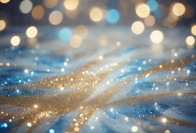 The primary subject of the image is a blue and gold patterned fabric. The setting is a blue background, and the visual style appears to be a photo. The colors and mood of the image are predominantly blue and gold, creating a warm and inviting atmosphere.