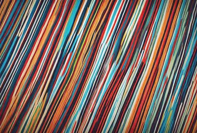 The primary subject of the image is a colorful striped pattern, which is the main focus of the image. The setting is a colorful background, and the visual style is a combination of photo and digital art. The dominant colors in the image are blue, red, and orange, creating a vibrant and lively atmosphere.