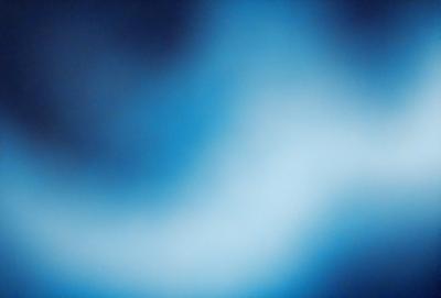 The primary subject of the image is a blue, swirling, and somewhat blurry background. The setting appears to be a dark, cloudy sky, with the swirling blue pattern creating a sense of depth and movement. The visual style of the image is a mix of photo and digital art, as it captures the swirling pattern in a somewhat blurry manner. The dominant colors in the image are blue and black, creating a moody and atmospheric mood.