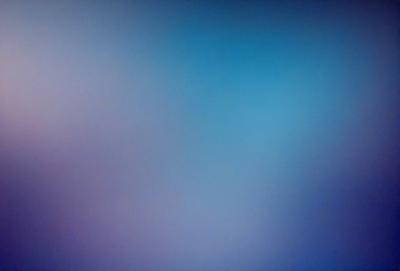 The primary subject of the image is a blue sky with a few clouds. The setting is a vast, open space with no visible landmarks or objects. The visual style is a natural, outdoor scene. The colors and mood are predominantly blue, creating a calm and serene atmosphere.