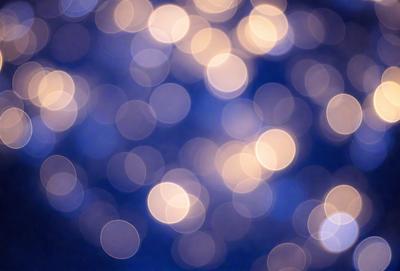 The primary subject of the image is a brightly lit, blue background with a pattern of white lights. The setting appears to be a nighttime scene, possibly a cityscape or a well-lit room. The visual style of the image is a combination of a photo and digital art, creating a unique and captivating atmosphere. The dominant colors are blue and white, with the white lights creating a sense of depth and contrast against the darker blue background. The overall mood of the image is one of beauty, tranquility,