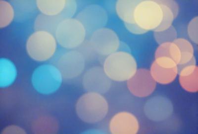 The primary subject of the image is a blue background with a pattern of bright, colorful lights. The setting appears to be a nighttime cityscape, with the lights creating a vibrant and lively atmosphere. The visual style of the image is a combination of digital art and illustration, as the lights are depicted in a way that resembles a painting or drawing. The colors and mood of the image are predominantly blue and bright, creating a sense of energy and excitement.